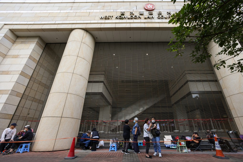 Dozens of residents queue outside West Kowloon Court in Cheung Sha Wan ahead of the sentencing hearing for 45 opposition figures. Photo: Eugene Lee