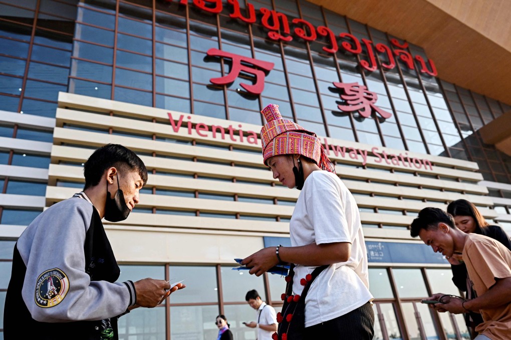 An official checks passengers’ tickets in front of Vientiane Railway Station. Laos borrowed billions of dollars from neighbour China to fund a US$6 billion high-speed railway and a series of major hydropower dams. Photo: AFP