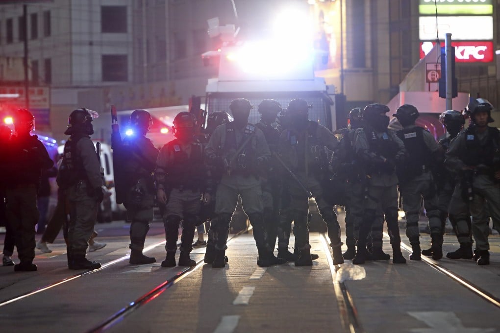 Police officers keep watch as protesters take to the streets on December 8, 2019. Photo: Winson Wong