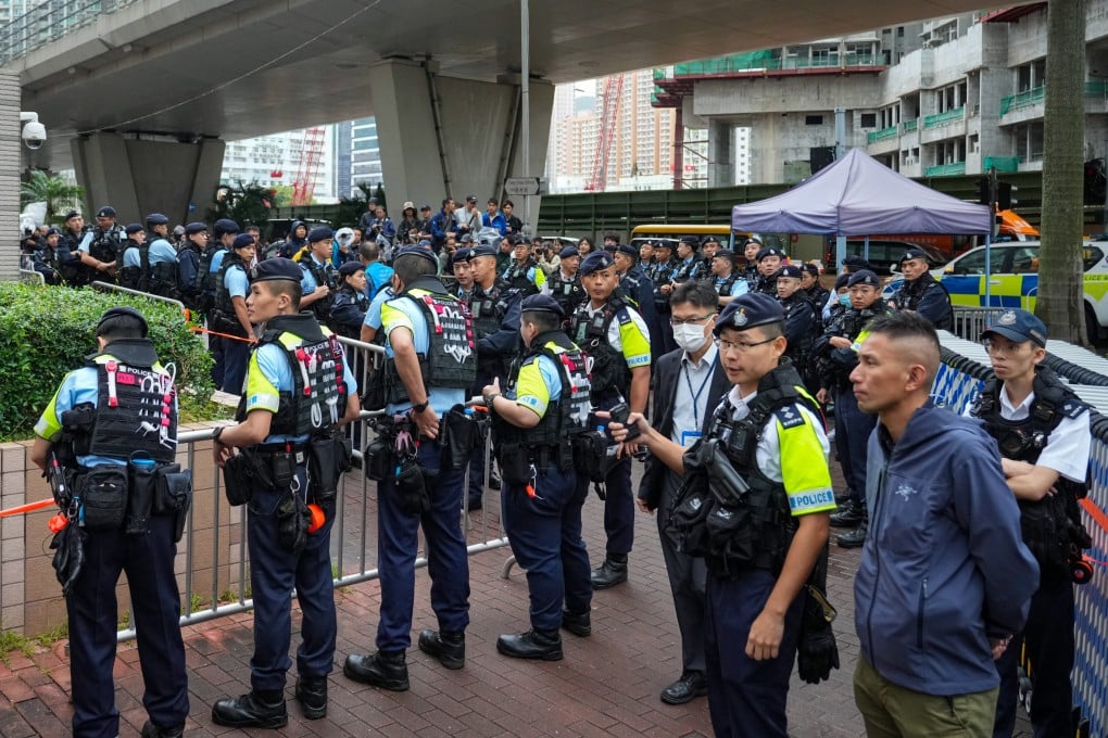 Police stand guard outside West Kowloon Court as Hong Kong’s landmark subversion trial draws to a close. Photo: Sam Tsang