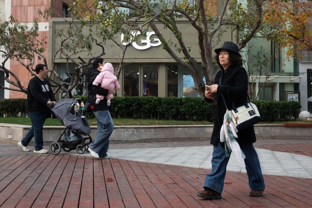 Pedestrians walk at a mall in Beijing. Photo: EPA-EFE
