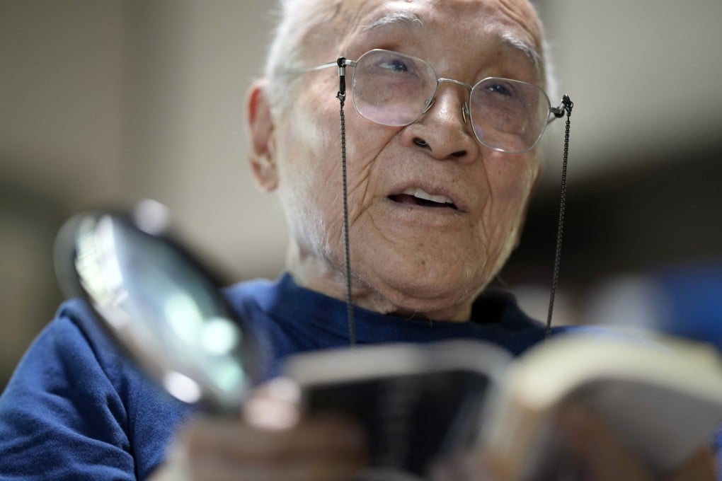 Japanese poet and translator Shuntaro Tanikawa reads a poem during an interview in 2022. Photo: AP