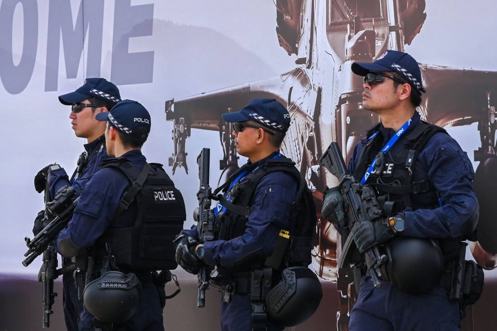Armed Singapore police. The suspects who agreed to forfeit assets have been barred from returning, Singapore Police Force said. Photo: AFP