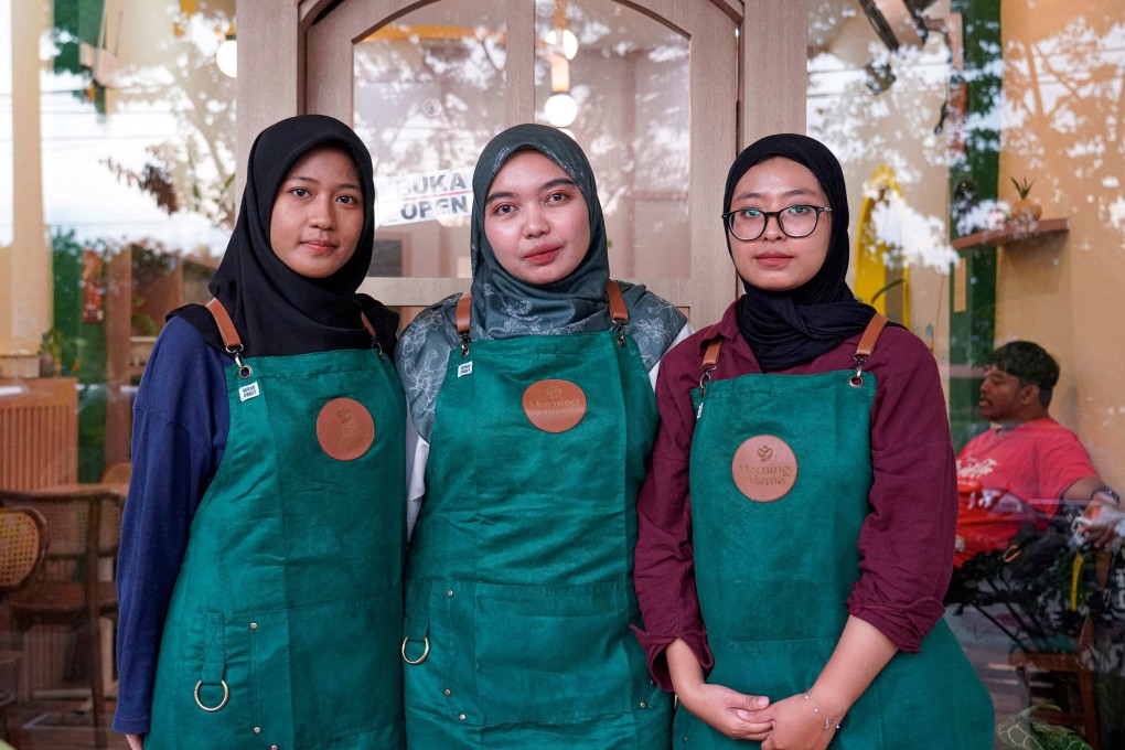 Qurrata Ayuni (centre), owner of Morning Mama, a coffee shop in Indonesia’s conservative Aceh province, with two of her staff. The cafe creates a space for women in a city where coffee shops have long catered to men. Photo: AFP