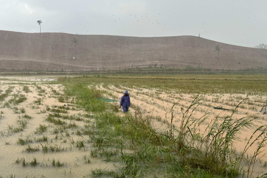 A farmer inspects his flooded rice field in Cagayan province, Philippines, on November 8. Photo: AFP