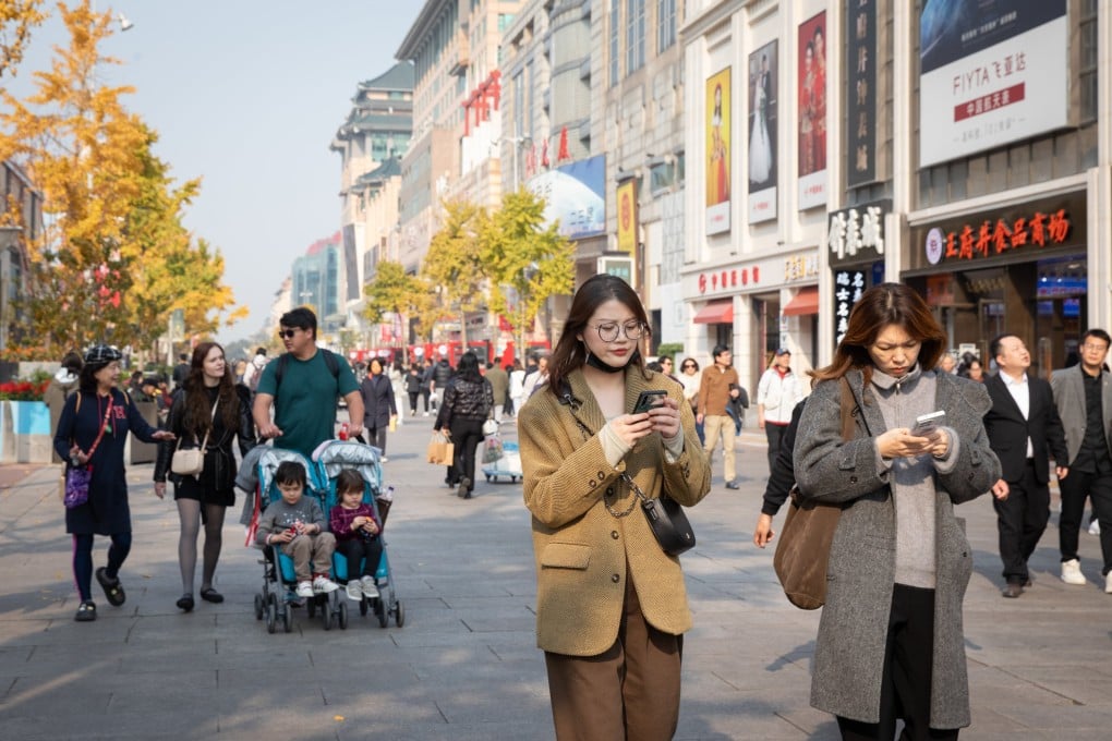 People walk on a shopping street in Beijing. Photo: EPA-EFE