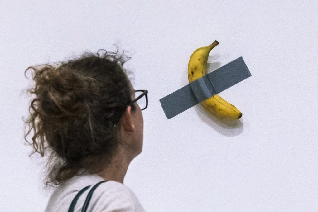 A woman looks at Italian artist Maurizio Cattelan’s Comedian sculpture during an auction preview at Sotheby’s in New York on November 11, 2024. Photo: AP