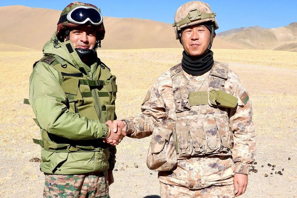 Soldiers from India and China shake hands along the Line of Actual Control near Karakoram Pass in Ladakh on October 31. Photo: Indian Army/AFP