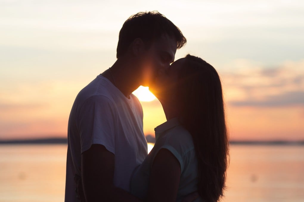 A loving young couple kissing at sunset. Photo: Shutterstock