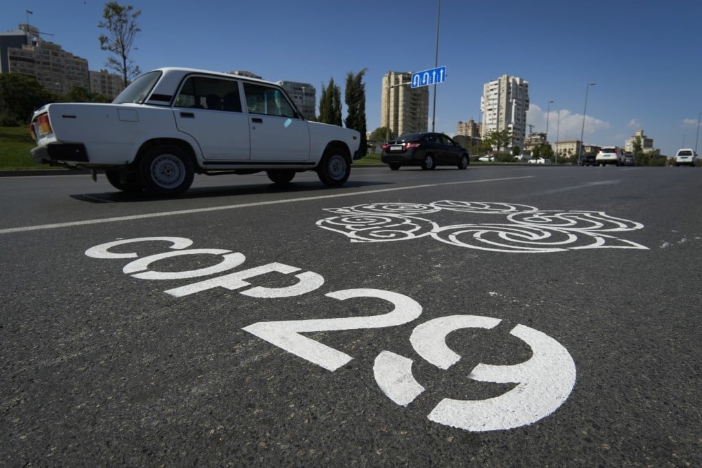 Motorists drive by the logo for the United Nations Climate Change Conference (Cop29), painted on a road in Baku, Azerbaijan, on September 16. Photo: AP