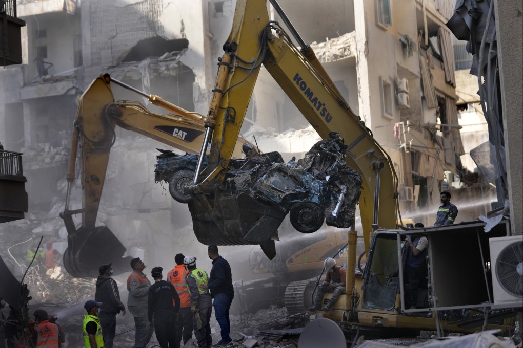 An excavator removes a destroyed car as rescue workers gather at the site of an Israeli airstrike that hit central Beirut, Lebanon, on Saturday. Photo: AP
