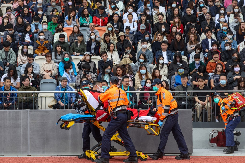 Emergency responders rush a man to safety during a five-hour drill exercise. Photo: Edmond So