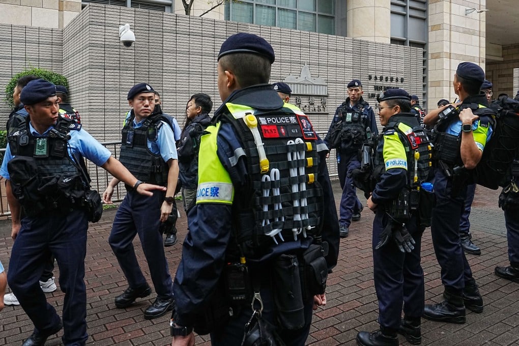 Police officers patrol outside the West Kowloon Law Courts Building. Photo: Elson Li