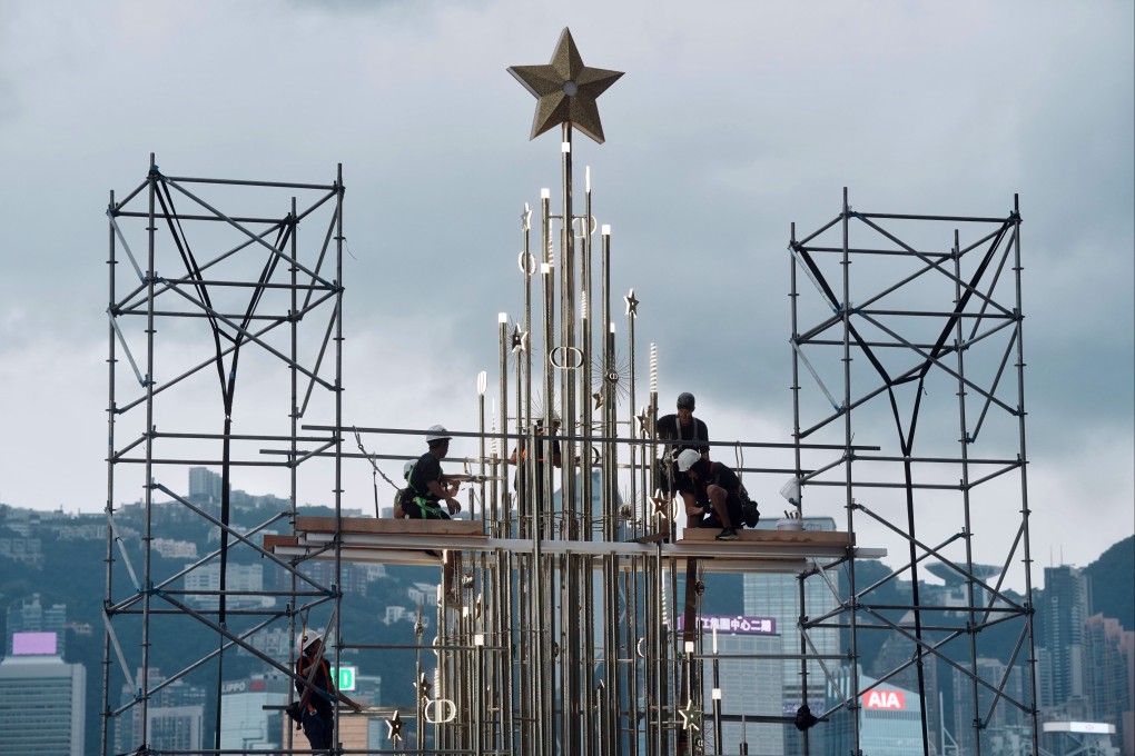 Workers are installing a mass Christmas decoration in an open area of Tsim Sha Tsui Promenade in the midst of unstable weather conditions on November 13, 2024. Photo: Elson Li