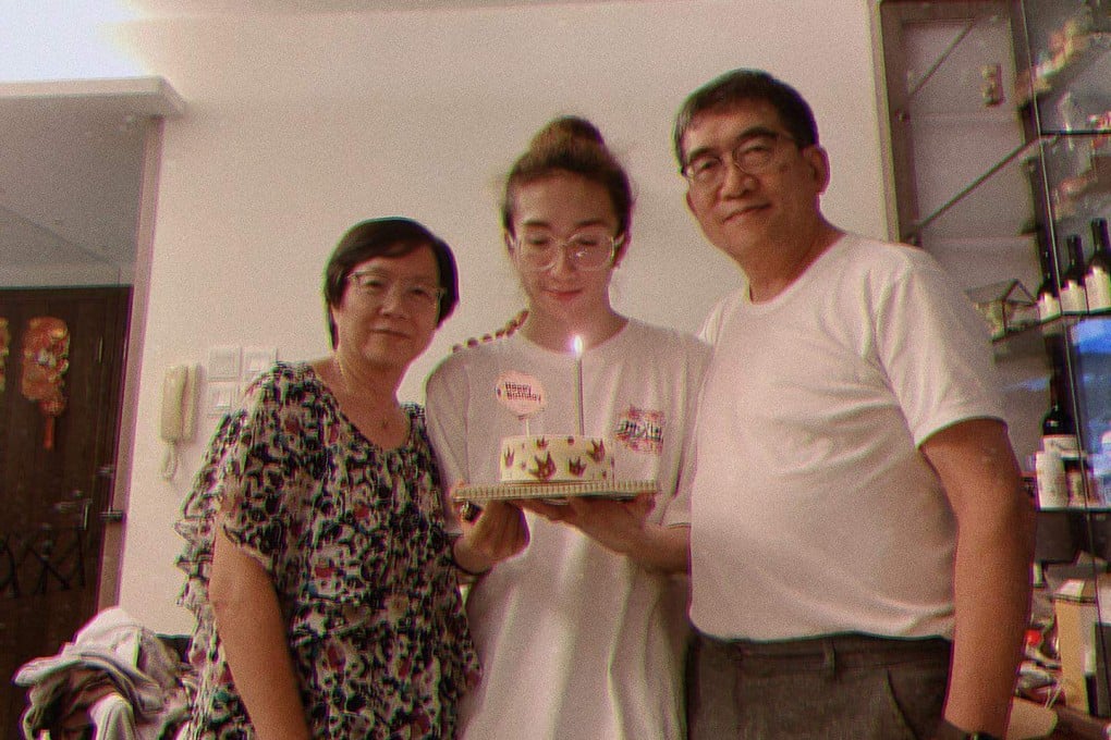 Mirror dancer Mo Li (centre), between his parents during a birthday celebration before he was seriously injured in July 2022. Photo: Instagram