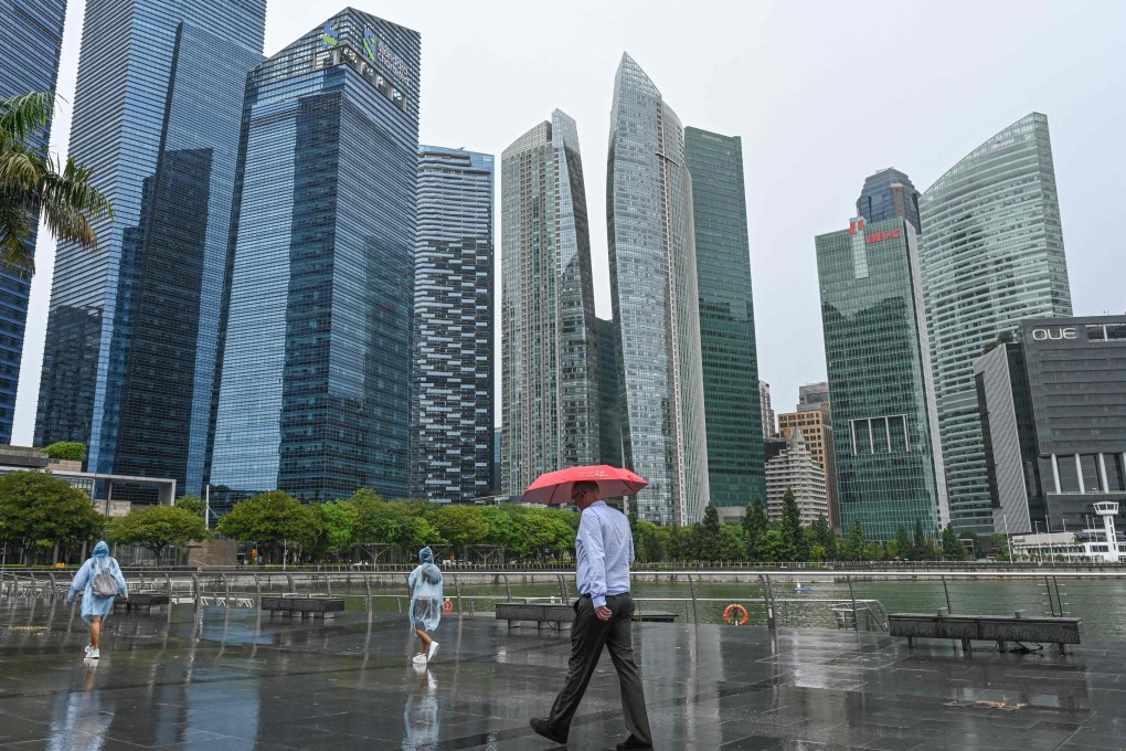 Pedestrians walk along the promenade near the financial district in Singapore on October 2024. Photo: AFP