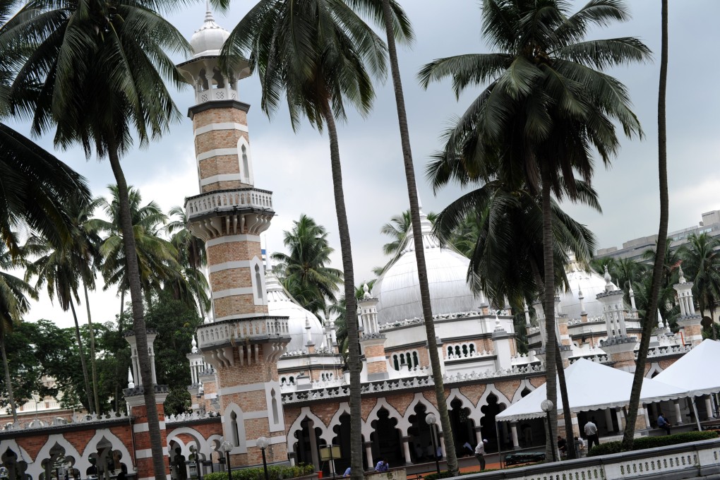 Muslims prepare to offer Friday prayers at the Jameh Masjid (mosque) in Kuala Lumpur. Malaysia operates parallel civil and sharia legal systems, with sharia law imposing an additional set of rules on Muslims. Photo: AFP