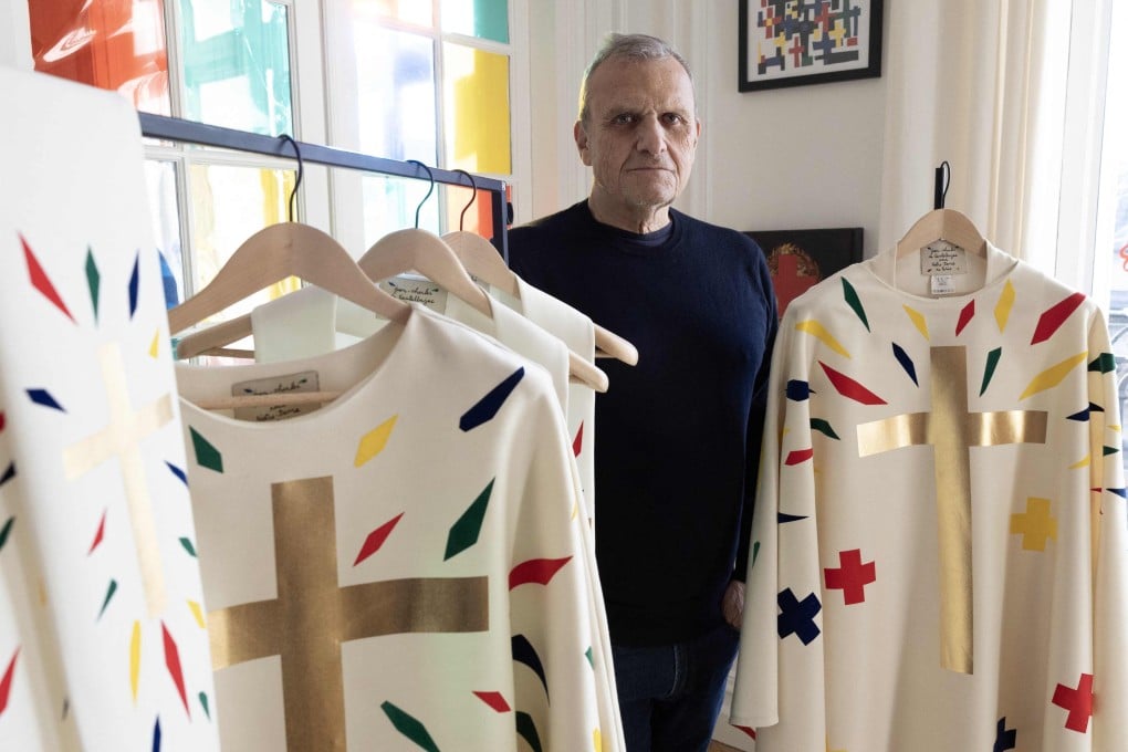 French fashion designer Jean-Charles de Castelbajac with some of the surprisingly minimalist priestly robes he has designed for the reopening of Paris’ Notre Dame cathedral. Photo: AFP