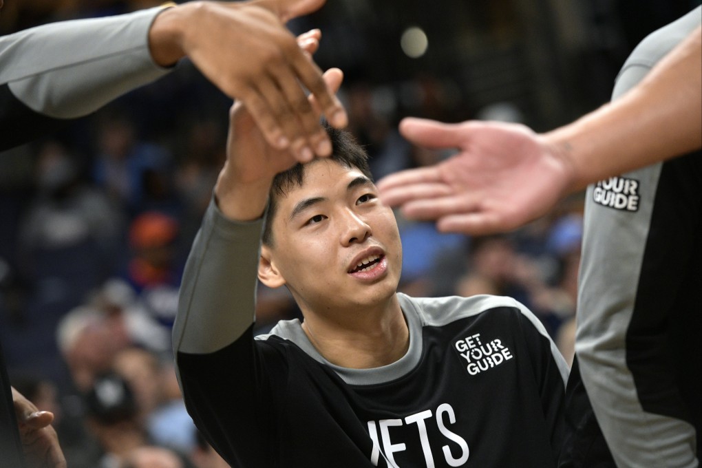 Brooklyn Nets guard Cui Yongxi high-fives teammates in the first half of an NBA game against the Memphis Grizzlies in October. Photo: AP