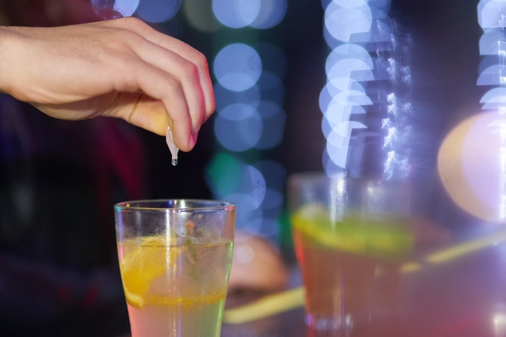 Always keep you eyes on your drink. Closeup shot of a man drungs into a drink in a nightclub.
