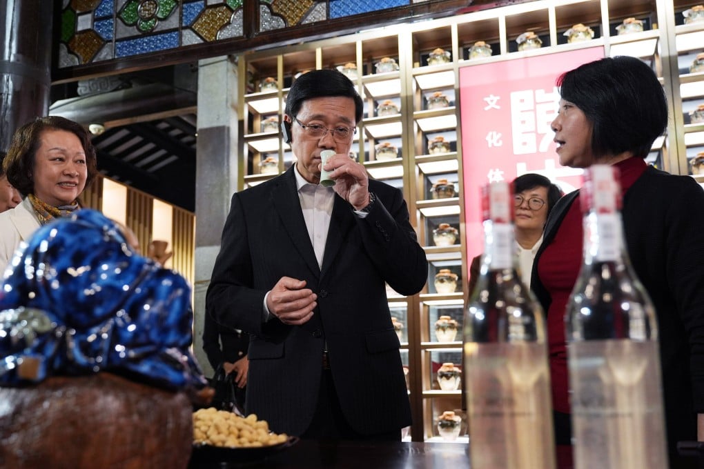 City leader John Lee examines wine products at Lingnan Tiandi, a revamped cultural and heritage site. Photo: Eugene Lee