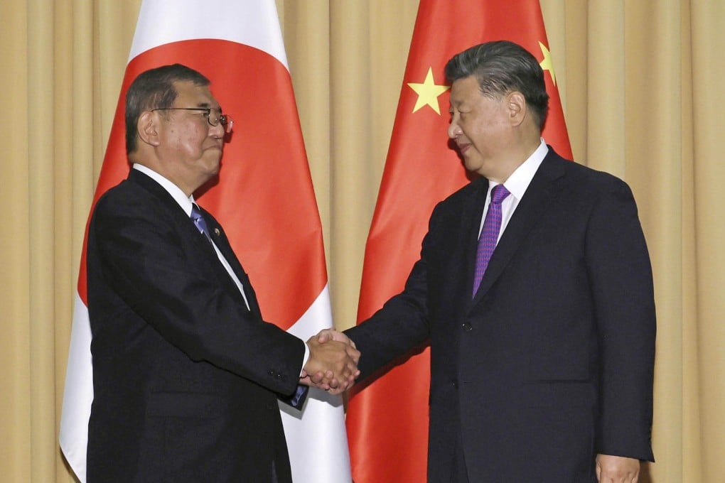 Japanese Prime Minister Shigeru Ishiba (left) and Chinese President Xi Jinping shake hands ahead of their talks in Lima on November 15. Photo: Kyodo
