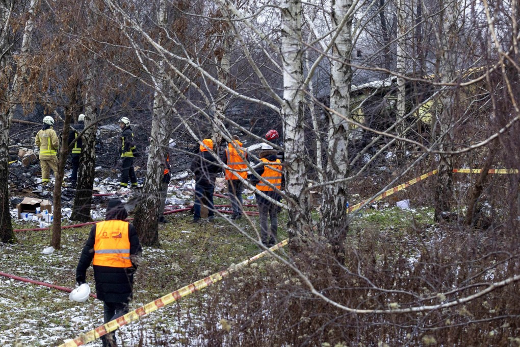 Lithuanian Emergency Ministry employees work near the place where a DHL cargo plane crashed into a house near the capital Vilnius on November 25. Photo: AP