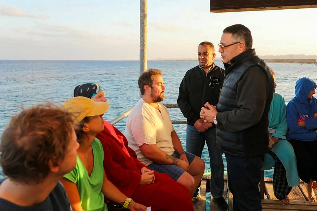 Red Sea governor Amr Hanafi speaks to survivors. Photo: Egyptian State Information Service via AFP