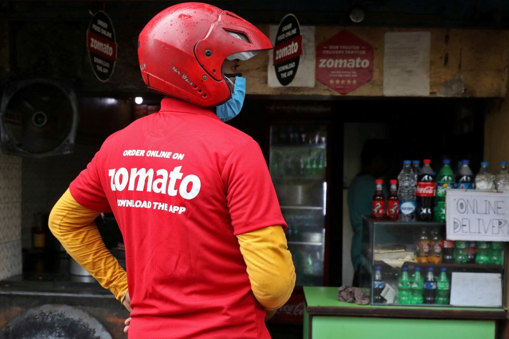 A delivery worker of Zomato, an Indian food-delivery startup, waits to collect an order in Kolkata. Photo: Reuters