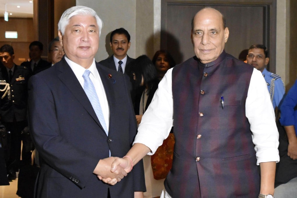 Japanese Defence Minister Gen Nakatani (left) shakes hands with his Indian counterpart Rajnath Singh ahead of their talks in Vientiane, Laos, on November 22. Photo: Kyodo