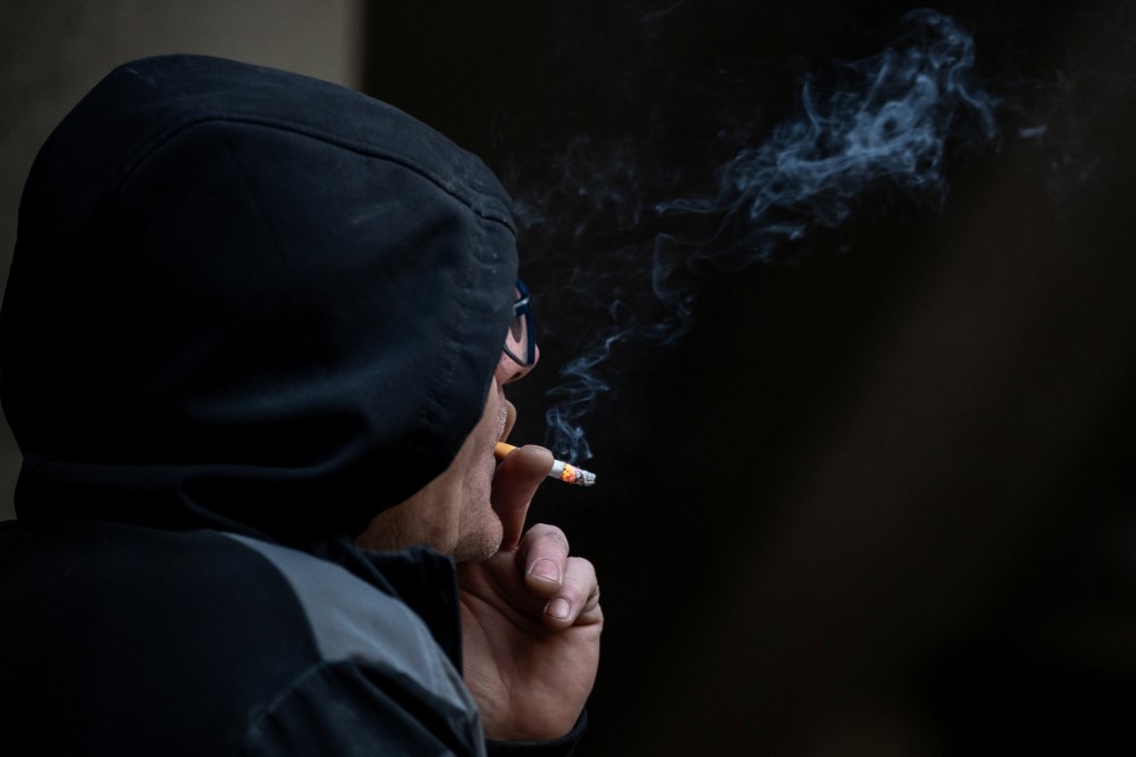 A man smokes a cigarette in London on Tuesday. Photo: Reuters