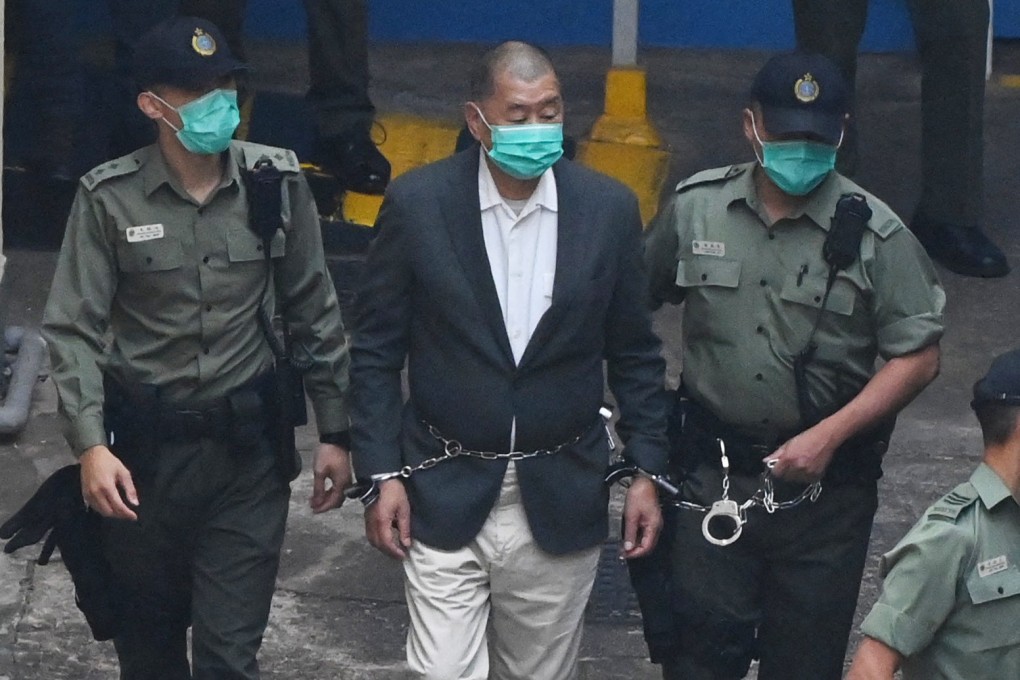 Former media boss Jimmy Lai is led into a police van by prison guards in December 2020. He returns to the witness box for his sixth day of oral testimony on November 28 this year. Photo: AFP