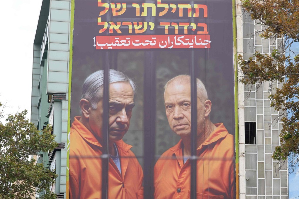 Images of Israeli Prime Minister Benjamin Netanyahu (left) and former defence minister Yoav Galant are seen on the side of a building in Tehran, Iran, on Tuesday with a message in Farsi and Hebrew that reads “Wanted criminals”. Photo: AFP