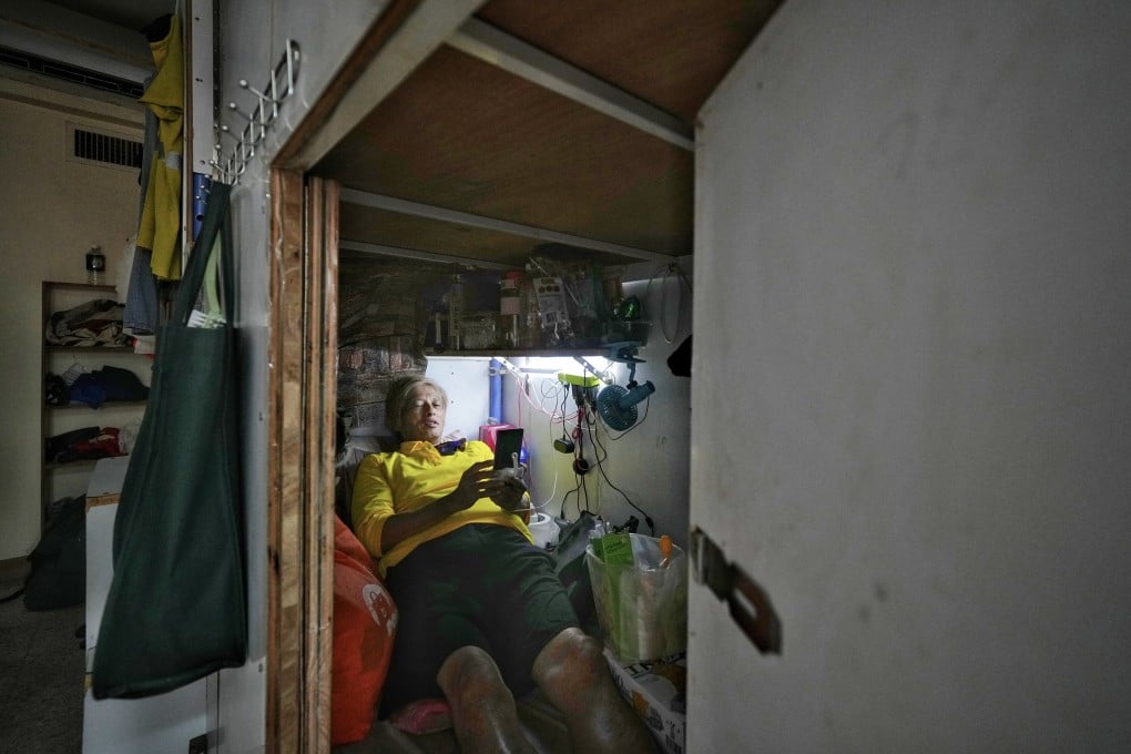 A subdivided tenant lays in his bunk bed space in Sham Shui Po. Photo: Elson Li