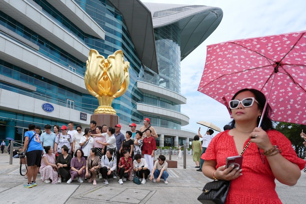A tour group visits Golden Bauhinia Square in Wan Chai. Photo: Eugene Lee