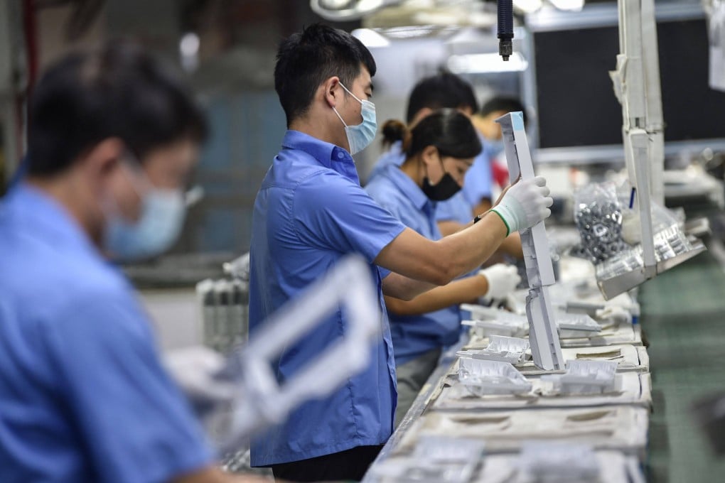 Workers producing washing machine parts at a factory in Nanjing, in China’s eastern Jiangsu province. Photo: AFP