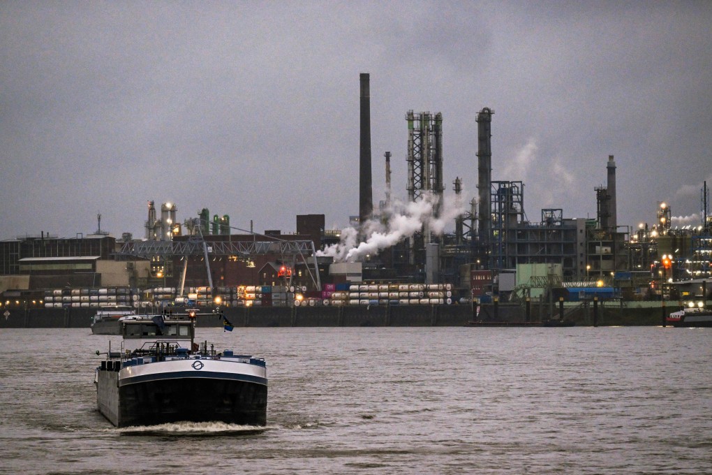 A vessel passes a German chemical and pharmaceutical plant on the banks of the Rhine river in Leverkusen, Germany, on November 25. Photo: AFP