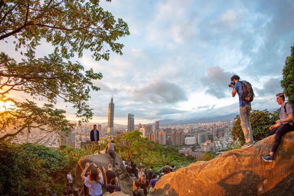 Tourists photograph Taipei’s skyline from Elephant Hill, one of the best places to hike to in Asian cities for relaxation, exercise and great views. Photo: Shutterstock