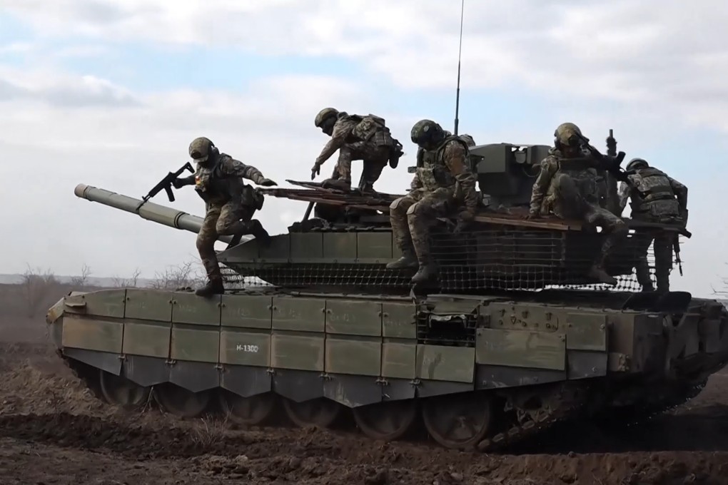 Russian servicemen jump off a tank during a combat training at an undisclosed location on November 27. Photo: Russian Defence Ministry Press Service via AP
