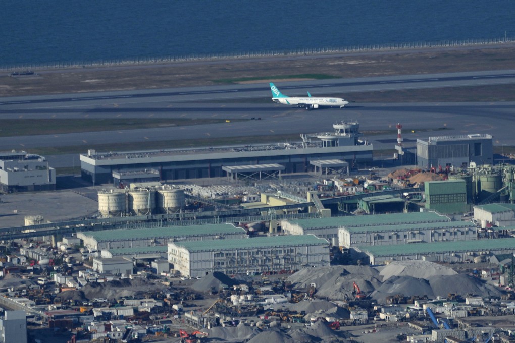 A Greater Bay Airlines air flight lands on the third runway of Hong Kong International Airport on the day of the three-runway system commissioning ceremony. Photo: SCMP / Elson Li