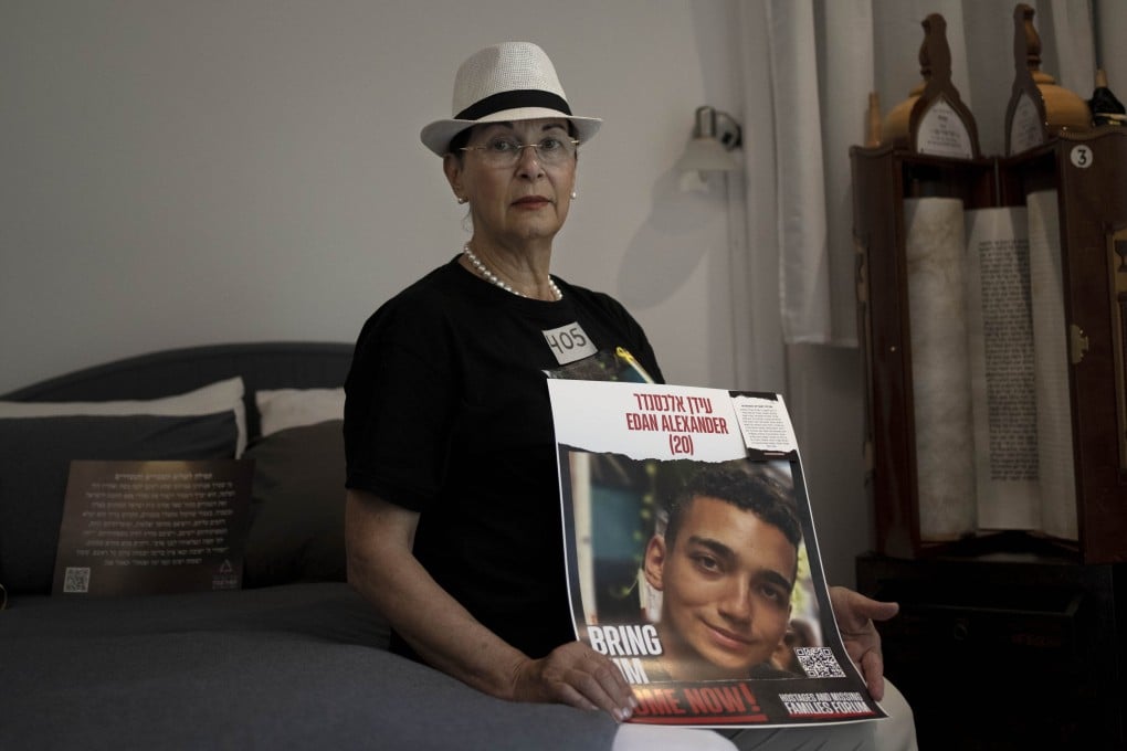 A poster depicting hostage Edan Alexander is held by his grandmother Varda Ben Baruch in his bedroom at home in Tel Aviv, Israel, on November 14. Photo: AP