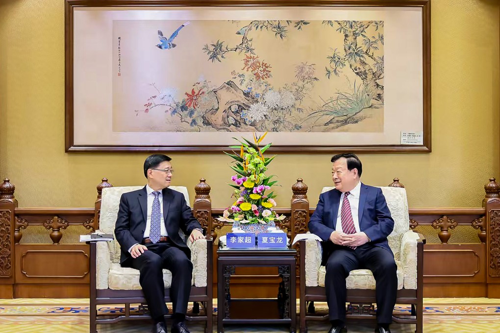 Hong Kong Chief Executive John Lee (left) talks to Xia Baolong, director of the Hong Kong and Macau Affairs Office, in Beijing on September 24. Photo: Hong Kong and Macau Affairs Office