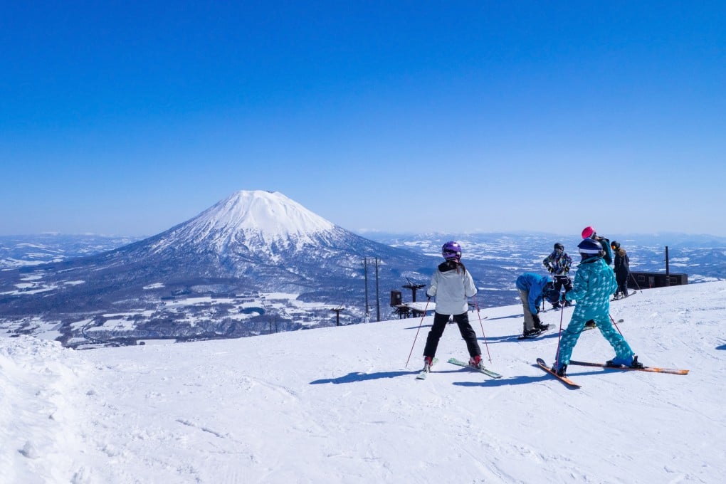 Skiers take a view of snow-capped Mount Yotei in Niseko, a town in Hokkaido, Japan. Photo: Shutterstock
