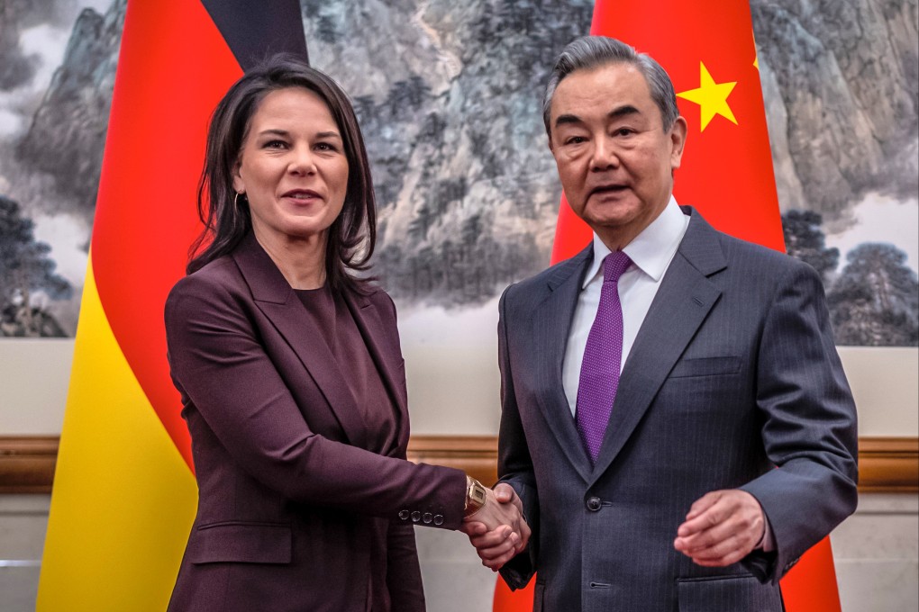 Chinese Foreign Minister Wang Yi greets Germany’s Annalena Baerbock, in Beijing on Monday. Photo: dpa