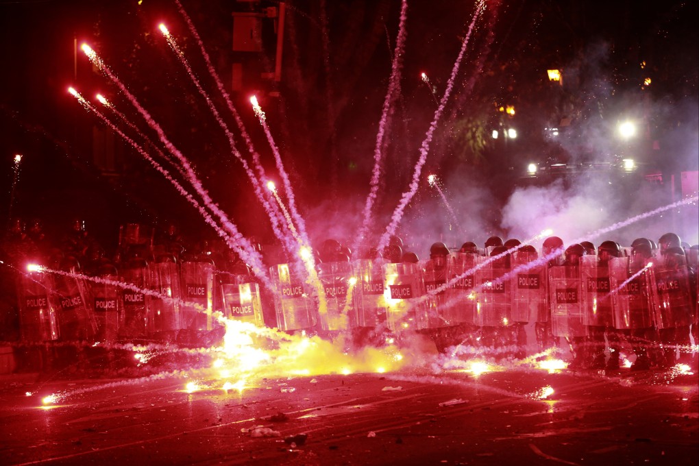 Demonstrators use firecrackers against police in Tbilisi, Georgia. Photo: AP