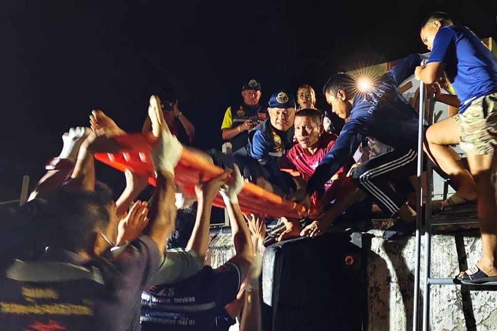 An injured Thai fisherman is carried on a stretcher at a port in Ranong, near the border with Myanmar, on Saturday. Photo: Thailand’s Third Naval Area Command/EPA-EFE