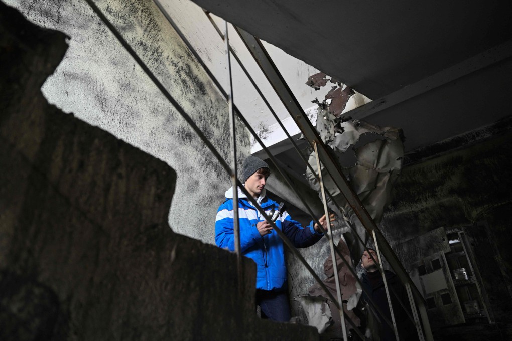 Alberto Blasco Ventas visits a destroyed building in Irpin, near Kyiv, in Ukraine. The Spanish would-be influencer is one of a growing number of foreign tourists drawn to the sites of Russian attacks in the country. Photo: AFP