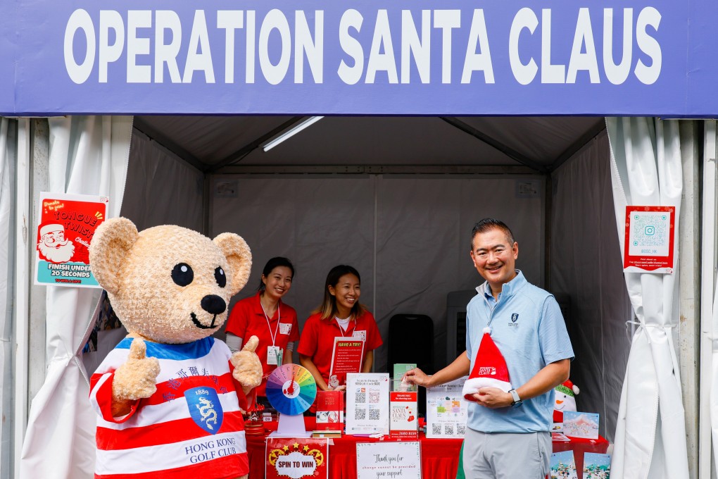 Golf club captain Andy Kwok visits the Operation Santa Claus booth. Photo: Handout