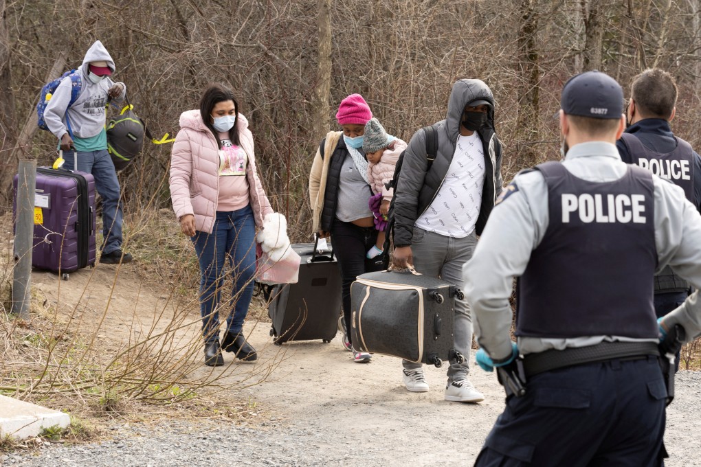 Asylum seekers cross into Canada from the US border near Hemmingford, Quebec in April 2022. Photo: Reuters