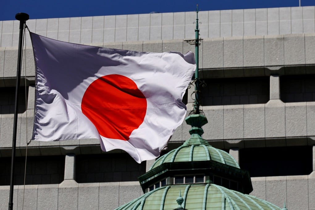 The Japanese national flag waves at the Bank of Japan building in Tokyo. Photo: Reuters